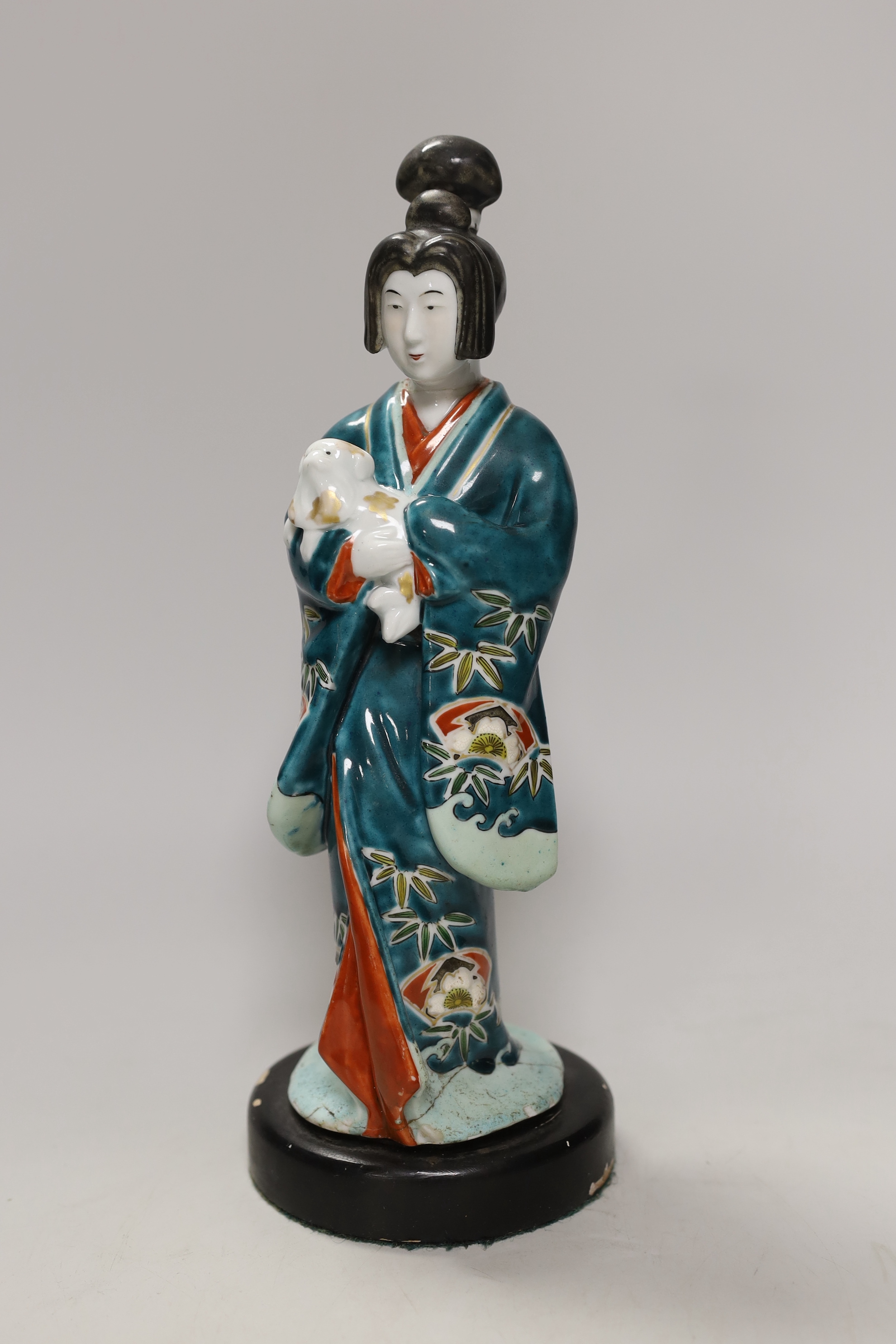 A Japanese Kutani figure of a Geisha and dog